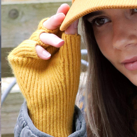 A person waring yellow knitted fingerless gloves.