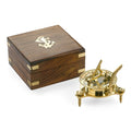 Detailed antique-style brass sundial next to a wooden box with anchor insignia.