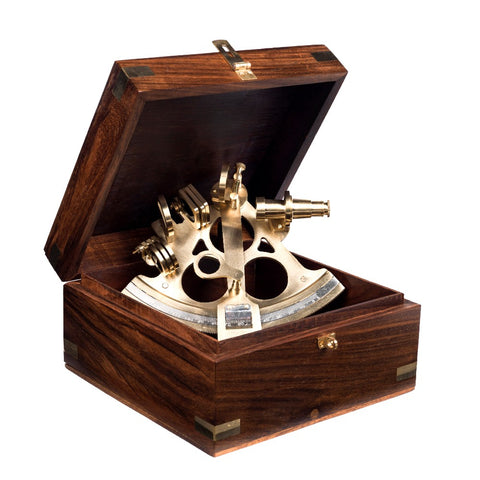 Brass sextant in a dark wooden display box.