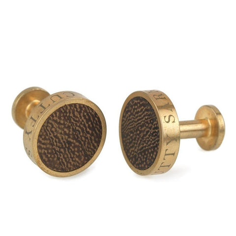 Brass cufflinks with wood inlay and Cutty Sark text.