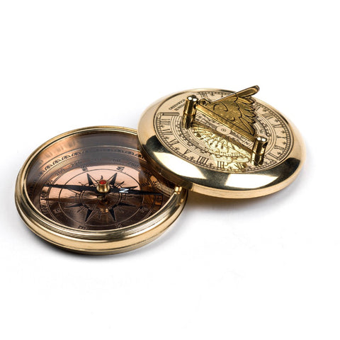 Etched brass compass with a sundial on the open lid.