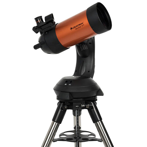 Orange and black telescope on a  tripod.