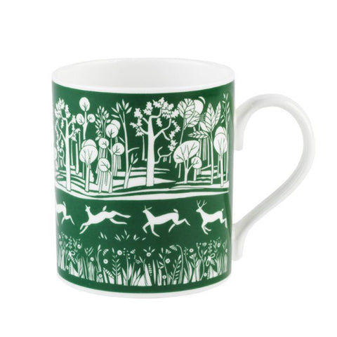 White mug with a green park illustration.