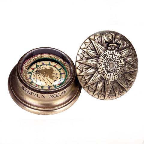 Ornate brass solar compass with lid off.