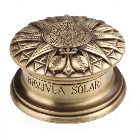 Ornate brass solar compass with lid on.