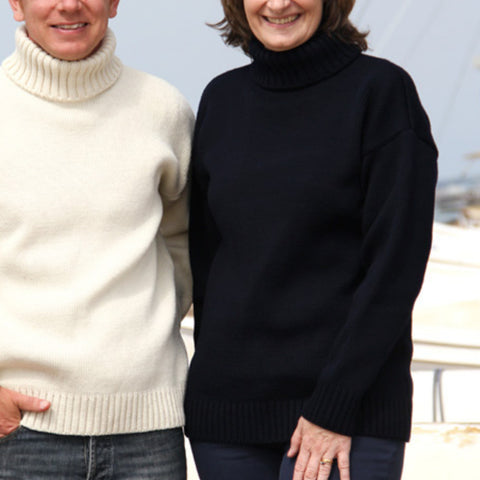 A man and a woman wearing cream and navy submariner sweaters.