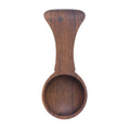 Dark wood tea scoop with handle.