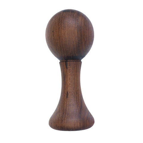 Back of dark wood tea scoop with handle.