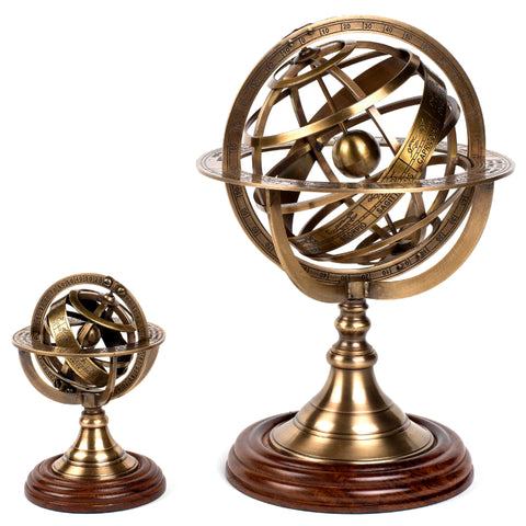 Small and large bronze armillary spheres with wooden bases are shown side by side for scale.