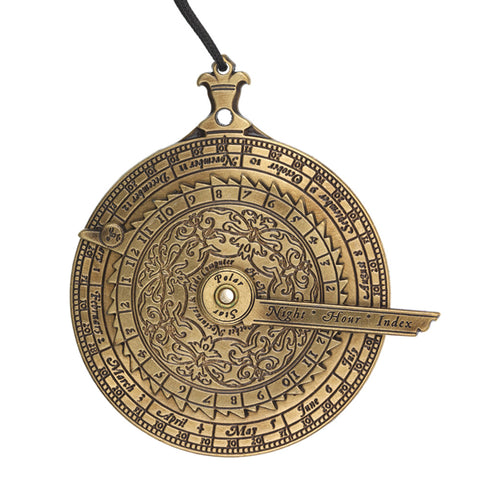 Circular brass instrument with calendar engravings and black string.