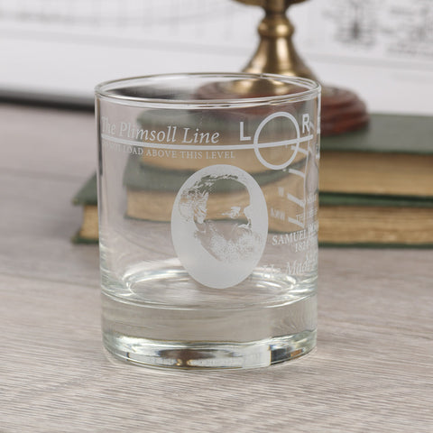 Whisky glass with Plimsoll Line etched design is shown in front of a blurred background.