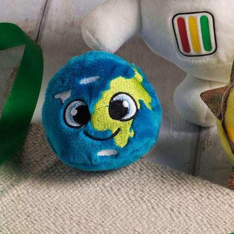 A round blue, white and green plush globe with smiley face.