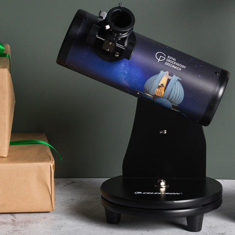 Black tabletop telescope on stand featuring a Royal Observatory Greenwich logo and image.