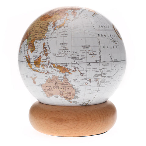 White and brown globe on a rounded wooden stand.