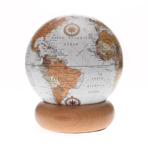 White and brown globe on a rounded wooden stand.